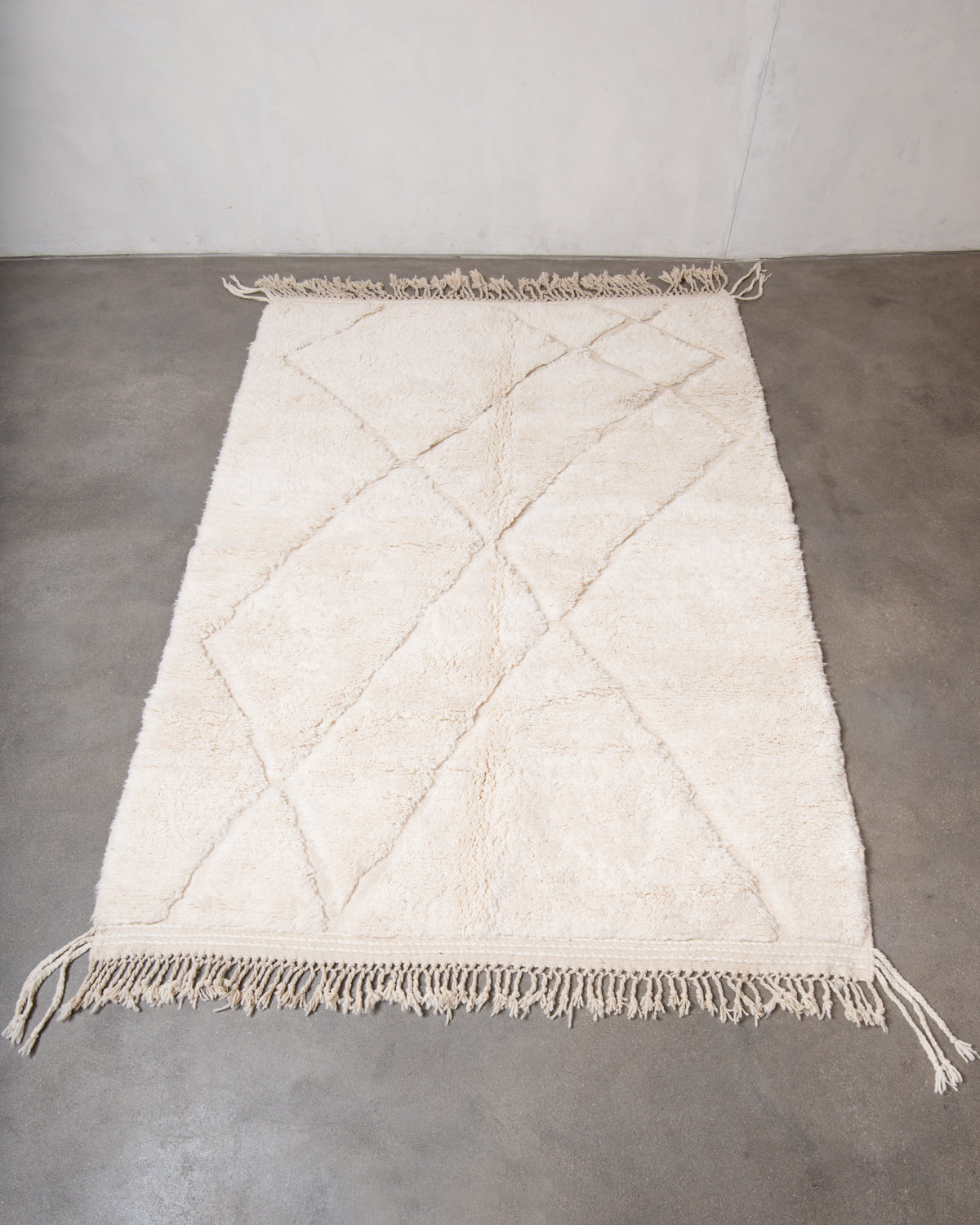 Modern, designer, handcrafted Berber rug from Morocco. Beniourain carpet with minimalist design, natural wool pile and a fluffy texture.